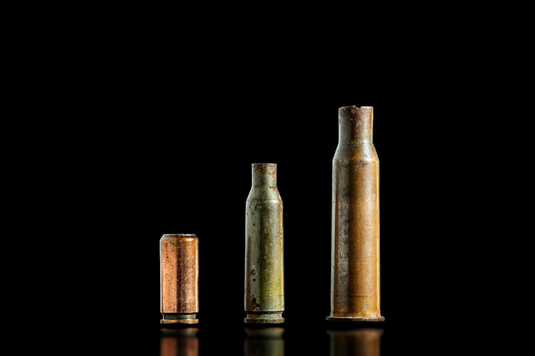 three-used-bullet-casings-sit-on-black-background-tn9-aox9mm4